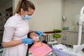 Woman patient receive procedure for teeth whitening bleaching with uv lamp