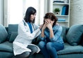 Woman patient receiving bad news. Friendly Doctor comforting and support sad patient with empathy Royalty Free Stock Photo