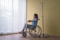 Woman patients sit alone on a wheelchair