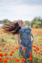 Woman in patterned sundress on sunset flower field Royalty Free Stock Photo