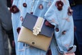 Woman with Paula Cademartori bag and blue jeans jacket with flowers and pearls decoration before Salvatore Royalty Free Stock Photo