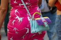 Woman with Paula Cademartori bag in turquoise, purple, yellow and pink colors, Milan