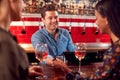 Woman Paying Barman For Drinks At Bar After Work Using Contactless Card Royalty Free Stock Photo