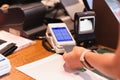 Woman paying bill at cafe by insert credit card in credit card reader. Royalty Free Stock Photo