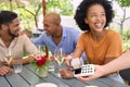 Woman Paying Bill At Outdoor Bar Or Restaurant Using Contactless App On Mobile Phone Royalty Free Stock Photo