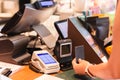 Woman paying bill through smart card in cafe. Royalty Free Stock Photo