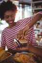 Woman paying bill through smartphone using nfc technology Royalty Free Stock Photo