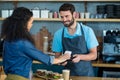 Woman paying bill through smartphone using NFC technology Royalty Free Stock Photo