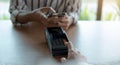 Woman paying bill through smartphone using NFC technology in a coffee. customer paying through mobile phone using contactless Royalty Free Stock Photo