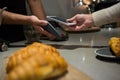 Woman paying bill through smartphone using NFC technology Royalty Free Stock Photo