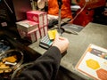 Woman paying Contactless at the shop counter with her HSBC Premier gold card