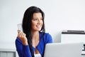 Woman paying with a credit card on the notebook