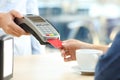 Woman paying with credit card reader in a bar Royalty Free Stock Photo