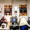 Woman Paying For Food Shopping At An Automated Till Point