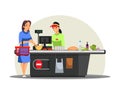 Woman paying for food at supermarket checkout, cashier in apron waiting for payment