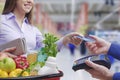 Woman paying for groceries using a credit card Royalty Free Stock Photo