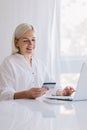 Woman paying with her credit card for online shopping Royalty Free Stock Photo