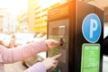 Woman is paying his parking using credit card at parking pay station terminal. Royalty Free Stock Photo