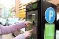 Woman is paying his parking using credit card at parking pay station terminal. Royalty Free Stock Photo