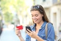 Woman paying online with a credit card outdoors Royalty Free Stock Photo