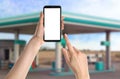Woman paying for refueling via smartphone at gas station, closeup. Device with empty screen Royalty Free Stock Photo