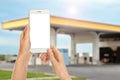 Woman paying for refueling via smartphone at gas station, closeup. Device with empty screen Royalty Free Stock Photo