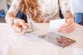 Woman paying restaurant bill with dollar banknotes