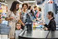 Woman paying with a smart watches in a grocery store