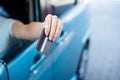 A woman pays with a credit card while refueling a car