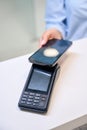 Woman pays for dental services by phone through a terminal