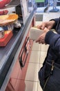 woman pays for food at the checkout in a supermarket