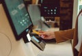 Woman pays at self-checkouts