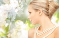 Woman with pearl necklace over cherry blossom Royalty Free Stock Photo