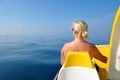 Woman on a pedal boat on water level in sunny day.