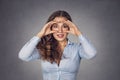 Woman, peeking through fingers like binoculars  surprised Royalty Free Stock Photo