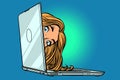 Woman peeking out of laptop