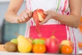 Woman peeling apple in kitchen Royalty Free Stock Photo