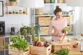 Woman peeling a carrot in kitchen