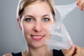 Woman Peeling Off A Facial Mask Royalty Free Stock Photo