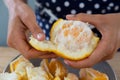 Woman peeling orange