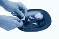 Woman peels garlic on plate, isolated, spicy seasoning. Horizontal photo, classic blue toning, trend 2020