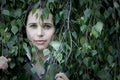 Woman peering through leaves