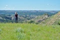 Woman peering out at a valley.