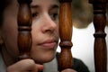 Woman peering through stair railings