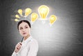 Woman with pen and many light bulbs Royalty Free Stock Photo