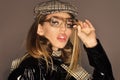 Woman on pensive face with make up wears checkered accessories and glasses for vision. lady in stylish outfit Royalty Free Stock Photo