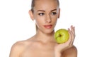 Woman with perfect skin. She holds in her hand a green apple