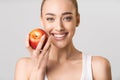 Woman With Perfect Smile Holding Apple Posing On Gray Background Royalty Free Stock Photo