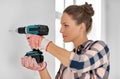 woman with perforator drilling wall at home Royalty Free Stock Photo