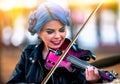 Woman perform music on violin park outdoor. Girl performing jazz . Royalty Free Stock Photo